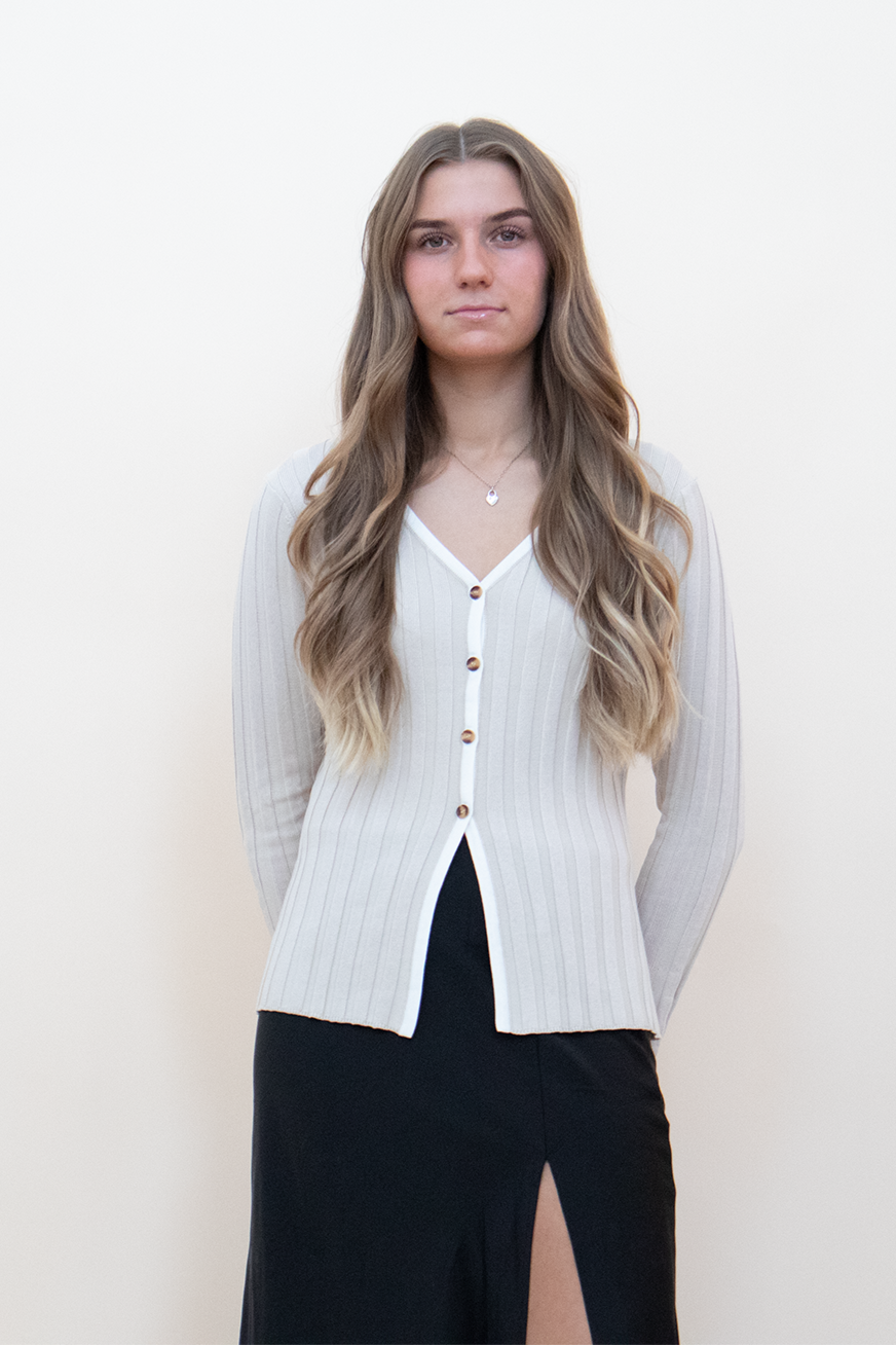 beige knit button up top, styled with a black skirt