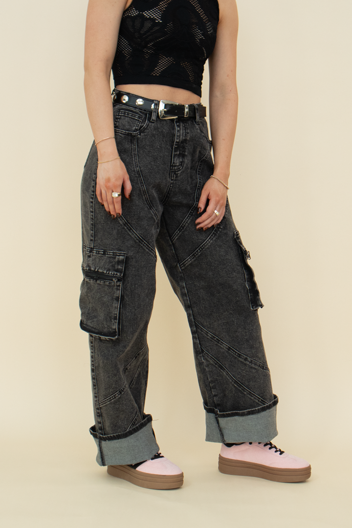 black cargo pant with seam detailing, styled with pink shoes and a black belt.
