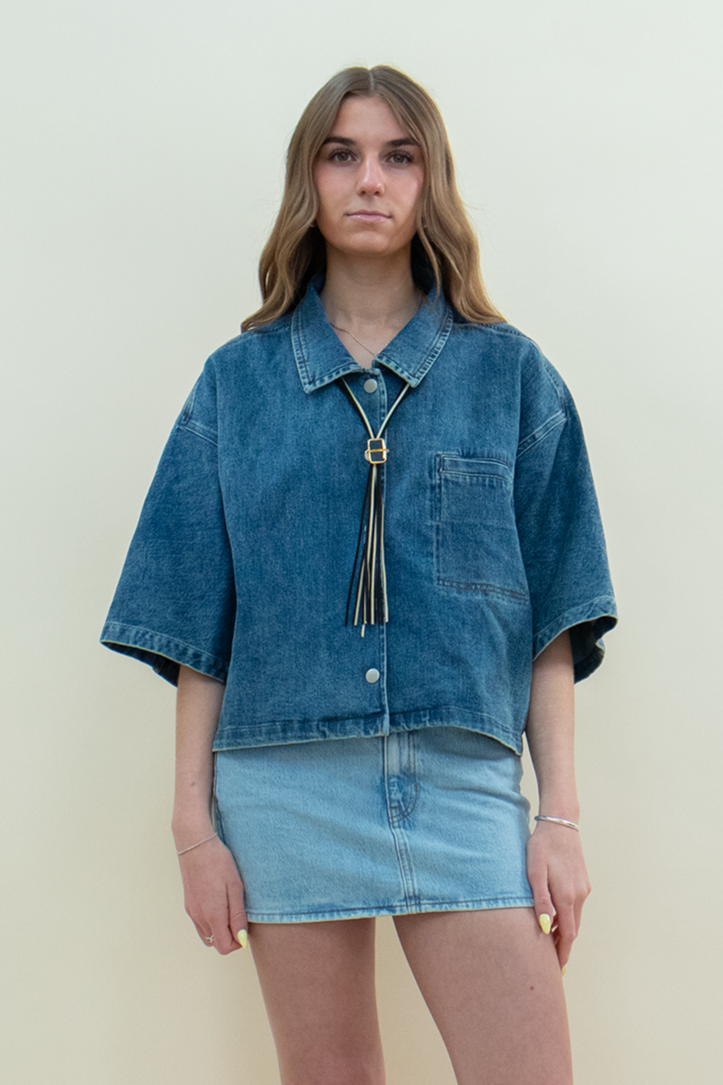 Model wearing Groove Closet light denim mini skirt styled with oversized boxy denim shirt.