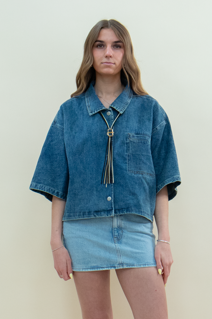 Model wearing Groove Closet light denim mini skirt styled with oversized boxy denim shirt.