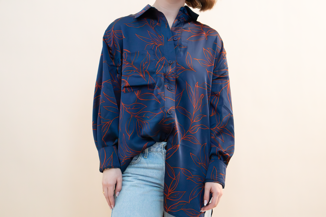 Trendy oversized navy button-up blouse with red leaf pattern, perfect for casual streetwear or effortless layering.