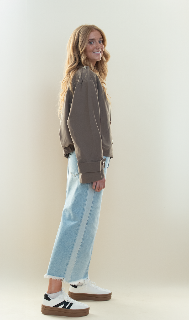 Taupe cropped double breasted trench jacket styled with a light wash two-tone denim maxi skirt and white platform sneakers
